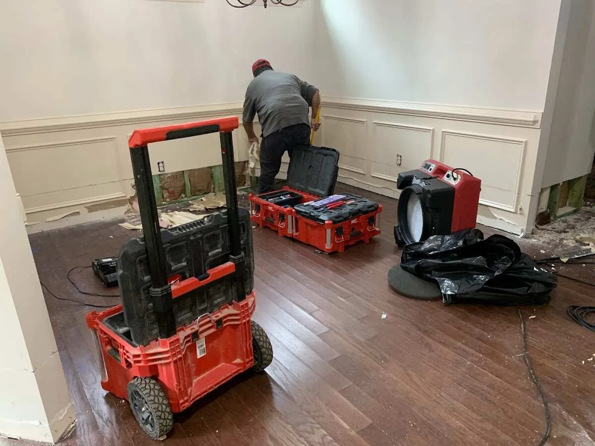 Technician setting up drying equipment for water damage in Live Oak